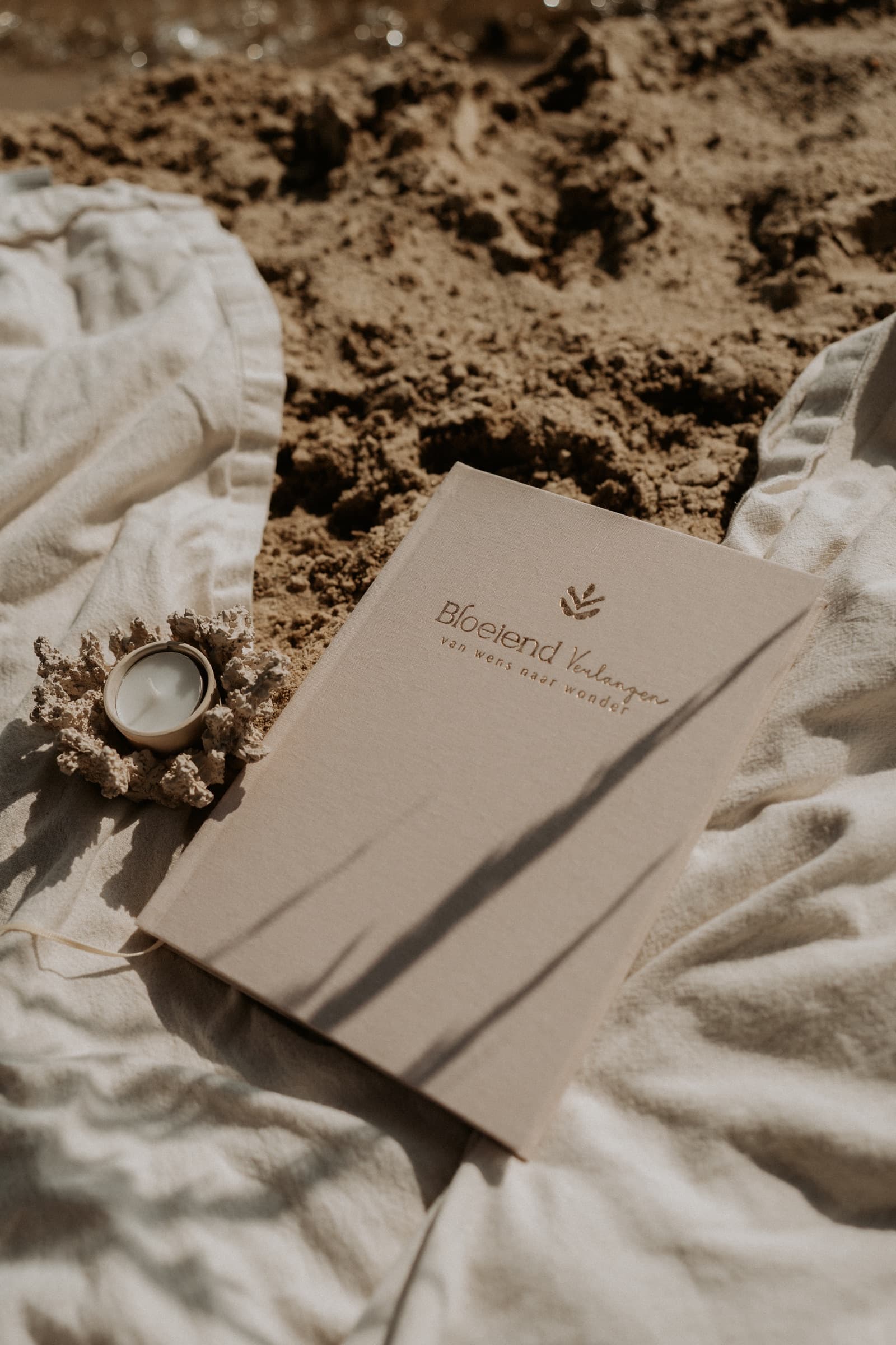 Het dagboek op linnen met een kaars en het strand op de achtergrond